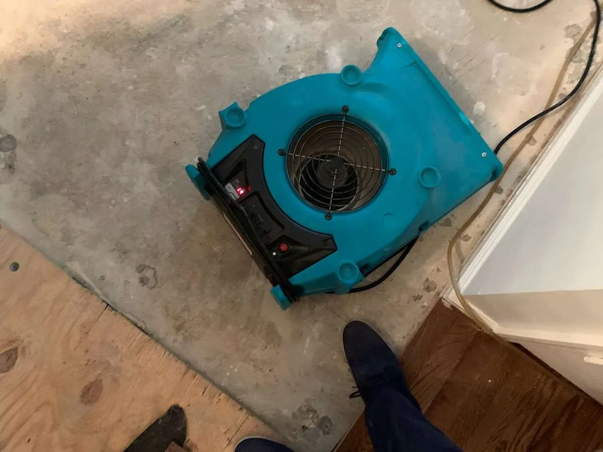 Air mover drying subfloor during Leak Detection & Repair in Vandalia
